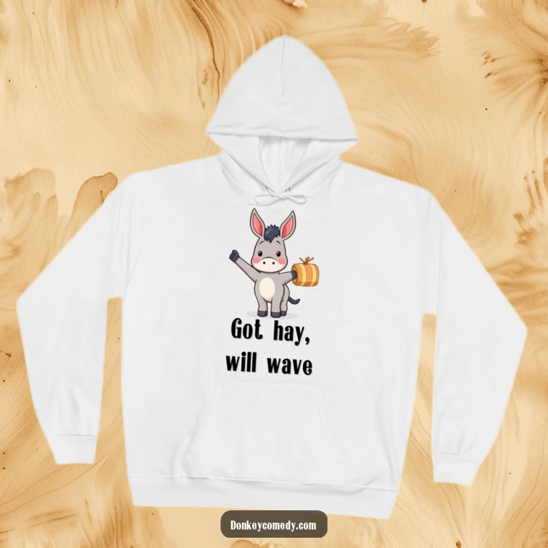 Funny hoodie featuring a donkey energetically waving a small striped hay bale, perfect for cozy, humorous moments.