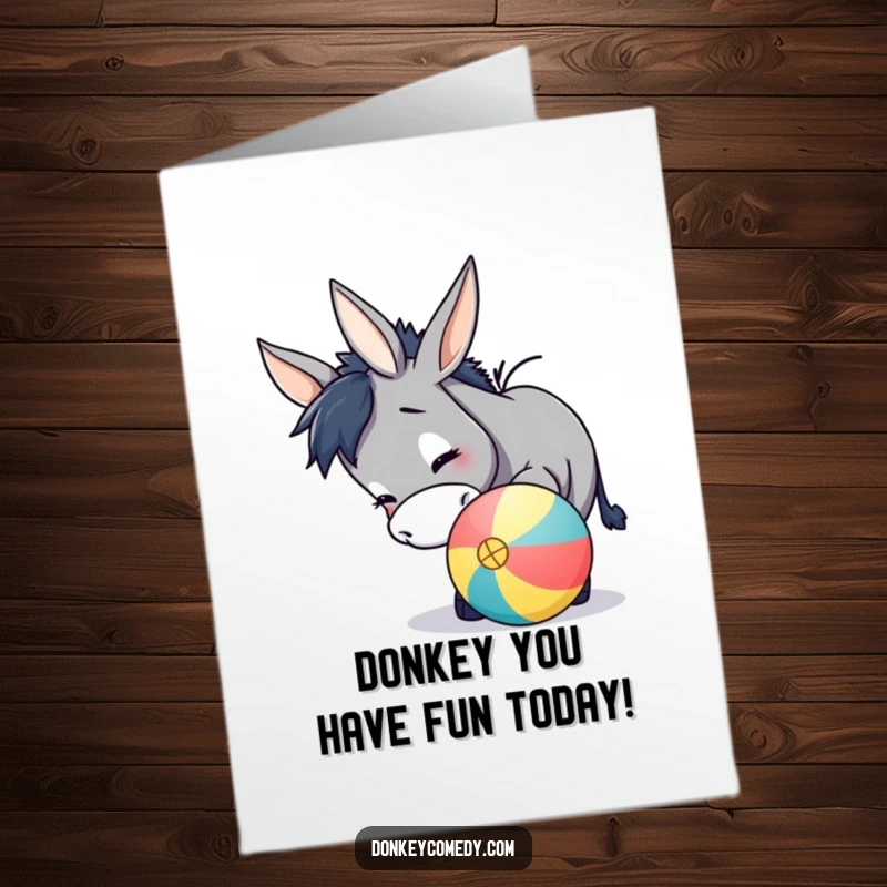 Funny Free Printable Birthday Card featuring a donkey playfully nudging a brightly colored ball with its nose, looking mischievous.