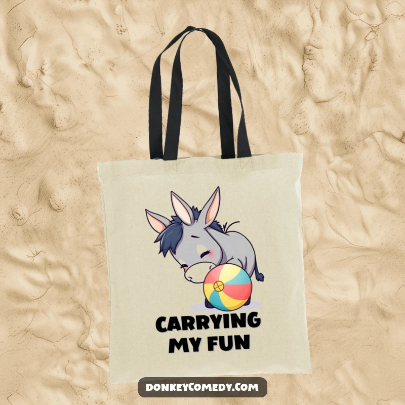Funny donkey tote bag showing a happy donkey playfully using its nose to nudge a bright, round ball, perfect for carrying fun.